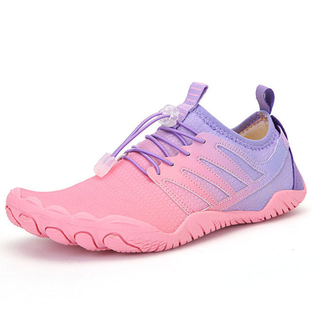 Barefoot running shoes, unisex, gray, worn on trail, highlighting natural foot position.