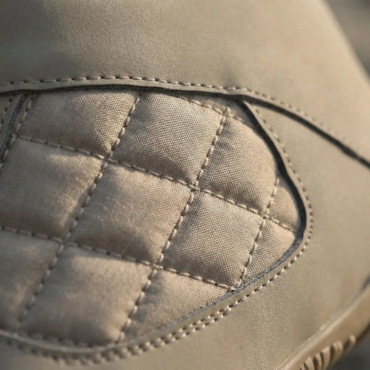 Close-up of black unisex barefoot winter ankle boots with fleece lining. Designed for natural feel & warmth.
