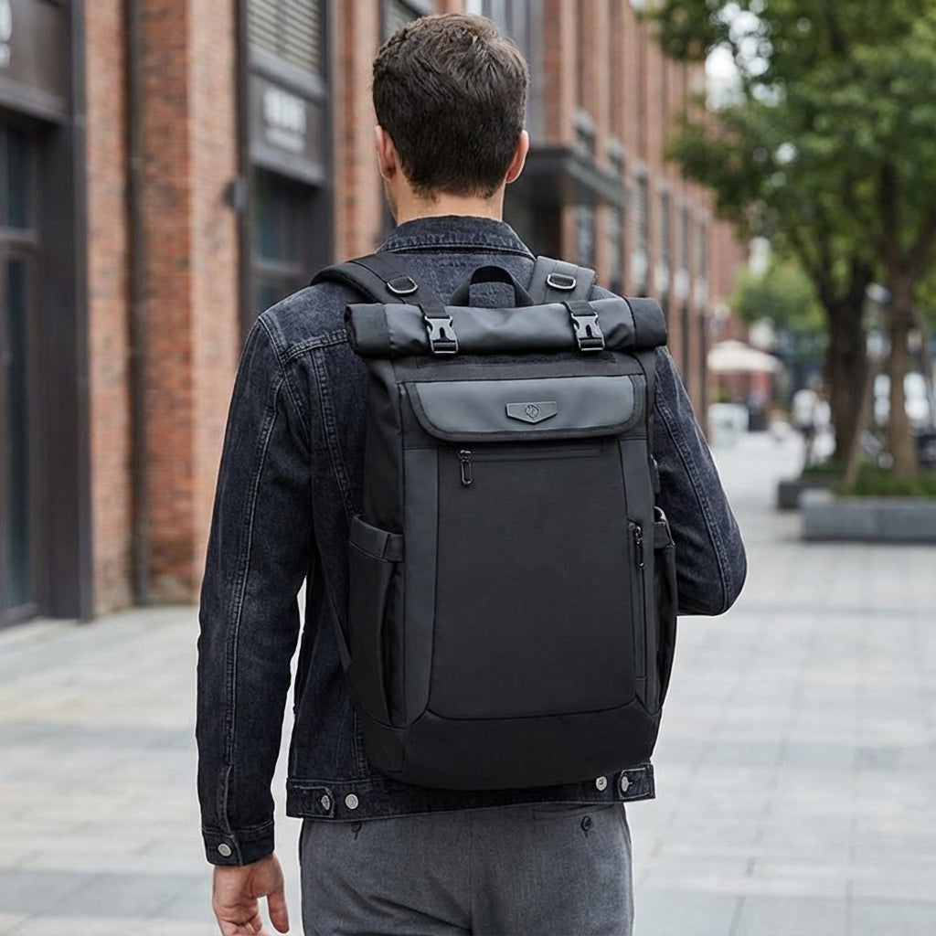Unisex black roll-top travel backpack, waterproof, with secure laptop compartment. Ideal for commuting & adventure.