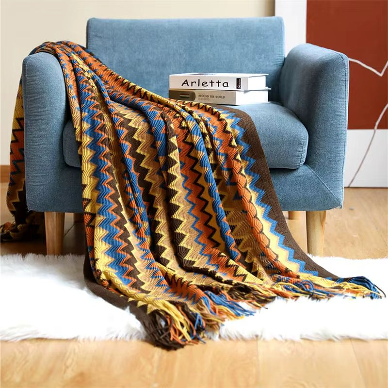 Unisex boho striped throw blanket with tassels, a cozy accent for living rooms.