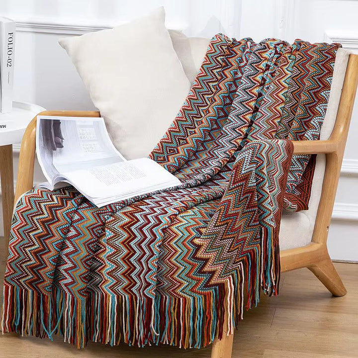 Warm & cozy boho striped throw blanket with tassels, ideal for snuggling in any room.