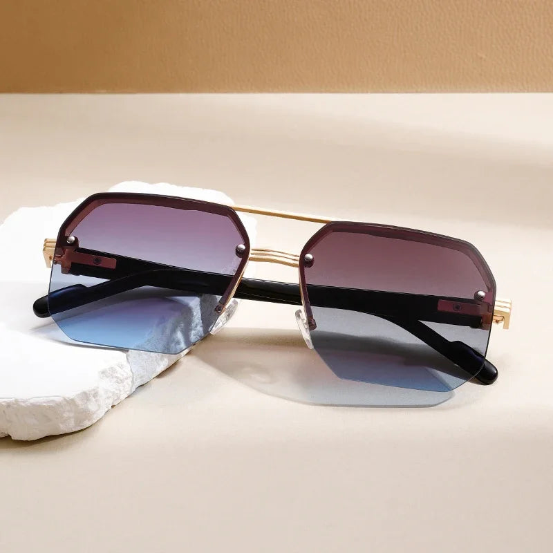 Fashionable unisex geometric shades with rimless design, UV protection, and gradient lenses.
