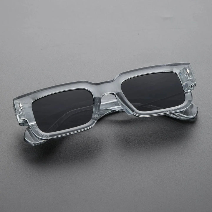 Bold rectangular UV protection shades in translucent black. Unisex fashion eyewear, a lightweight statement accessory.