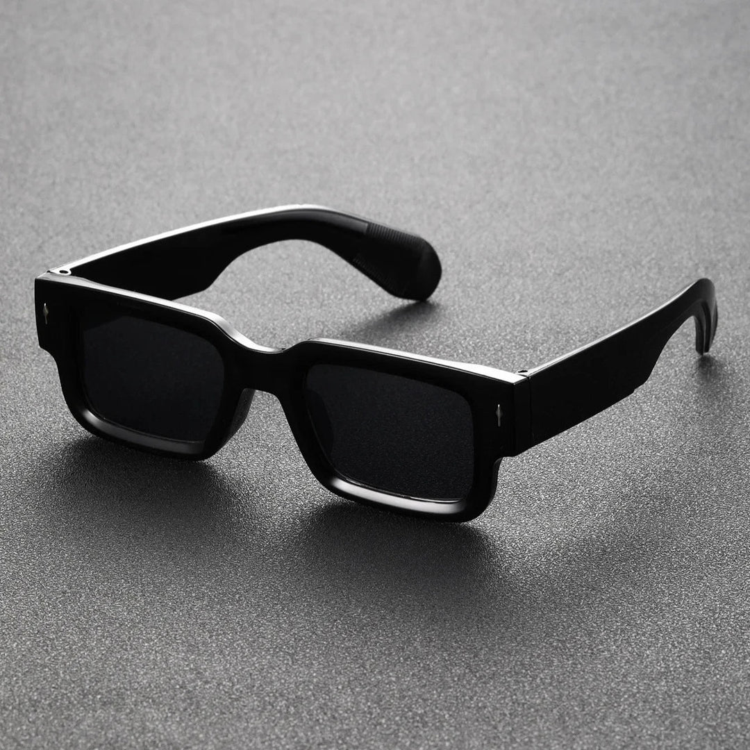 Black translucent rectangular shades offering UV protection. Lightweight unisex eyewear, perfect bold fashion accessory.