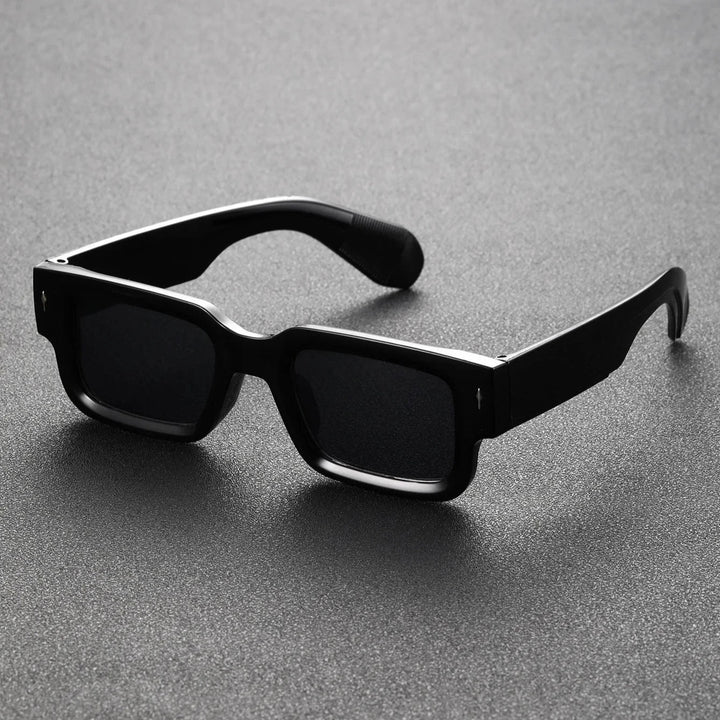 Black translucent rectangular shades offering UV protection. Lightweight unisex eyewear, perfect bold fashion accessory.