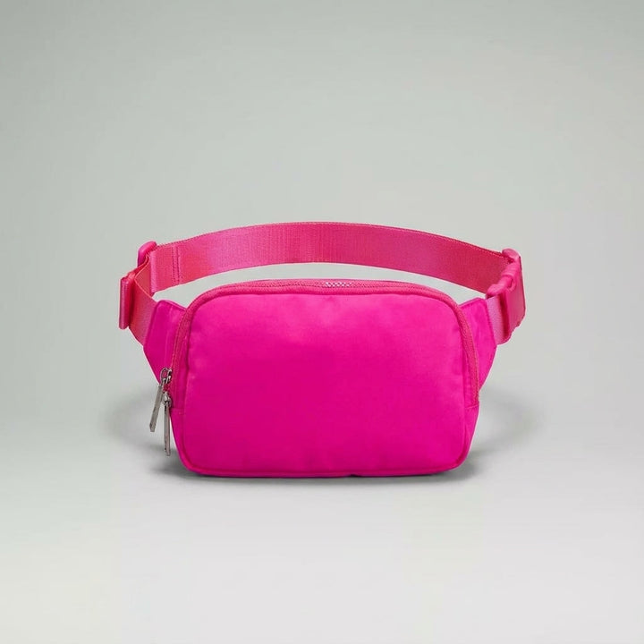 Organized unisex hip pack, black nylon for durability. Ideal for travel accessories & daily essentials.