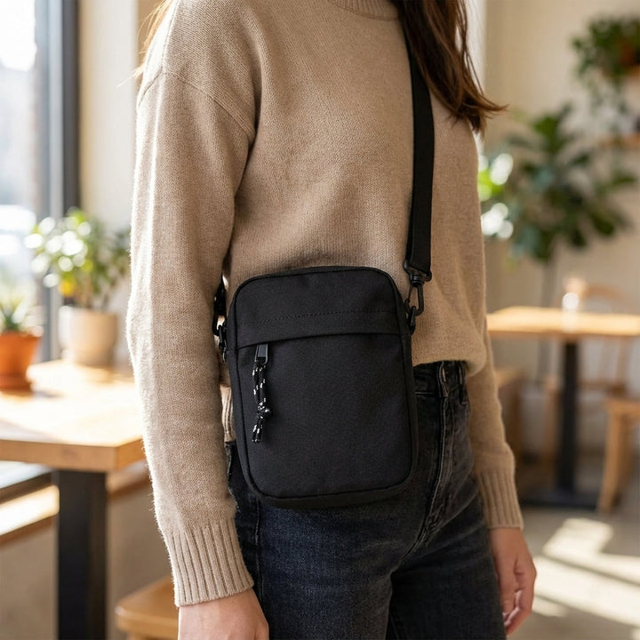 Unisex compact waterproof crossbody bag for secure everyday carry. Lightweight nylon shoulder bag, ideal for travel.