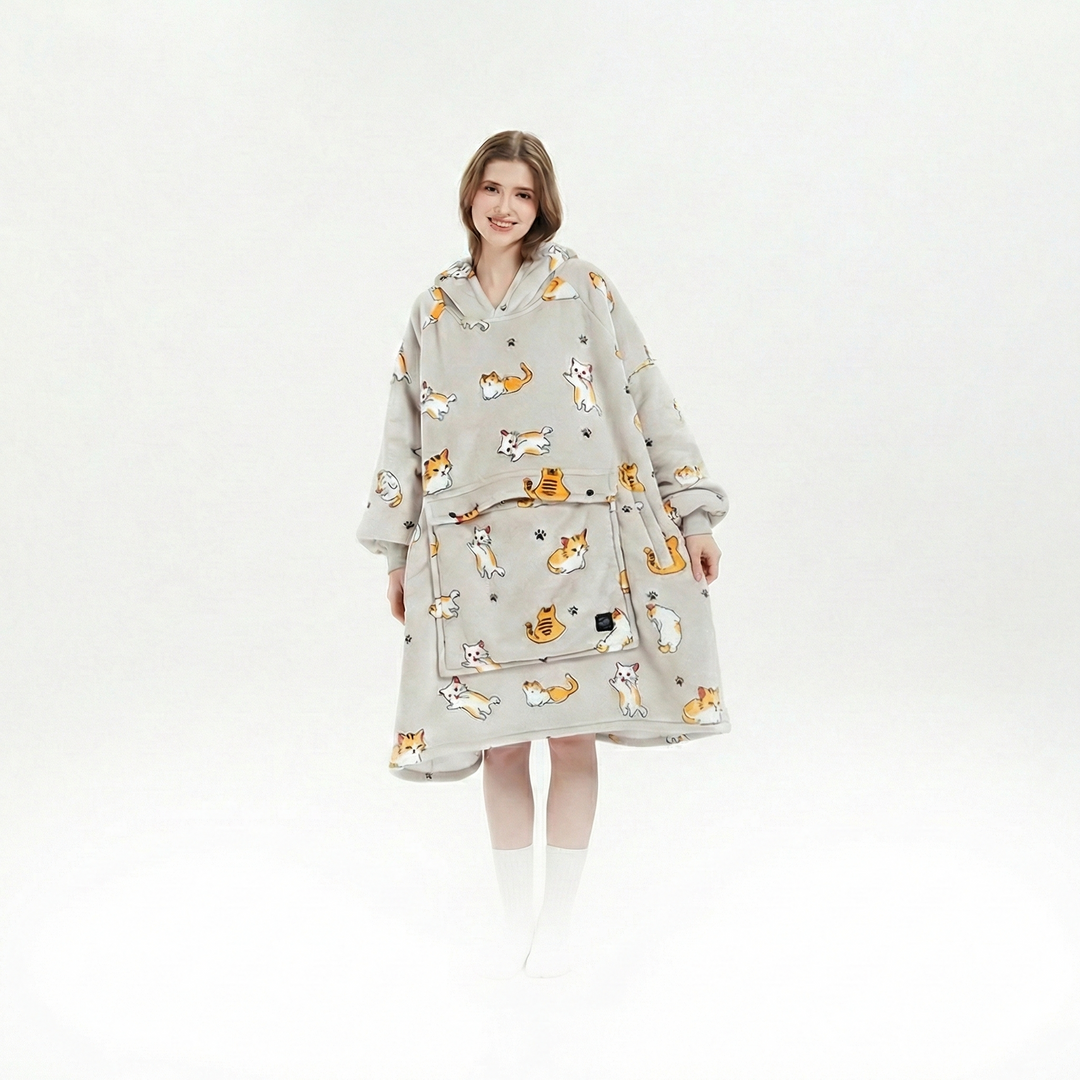 Unisex cordless heated flannel hoodie blanket draped over a chair, inviting coziness and warmth for any winter moment.