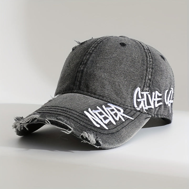 Distressed denim cap, "Never Give Up" embroidered. Unisex, frayed edge, casual wear baseball hat.