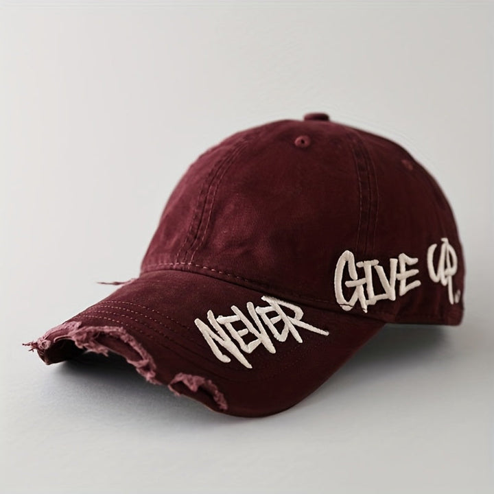 Washed denim "Never Give Up" baseball cap. Unisex, distressed, adjustable, and frayed for a cool, casual look.
