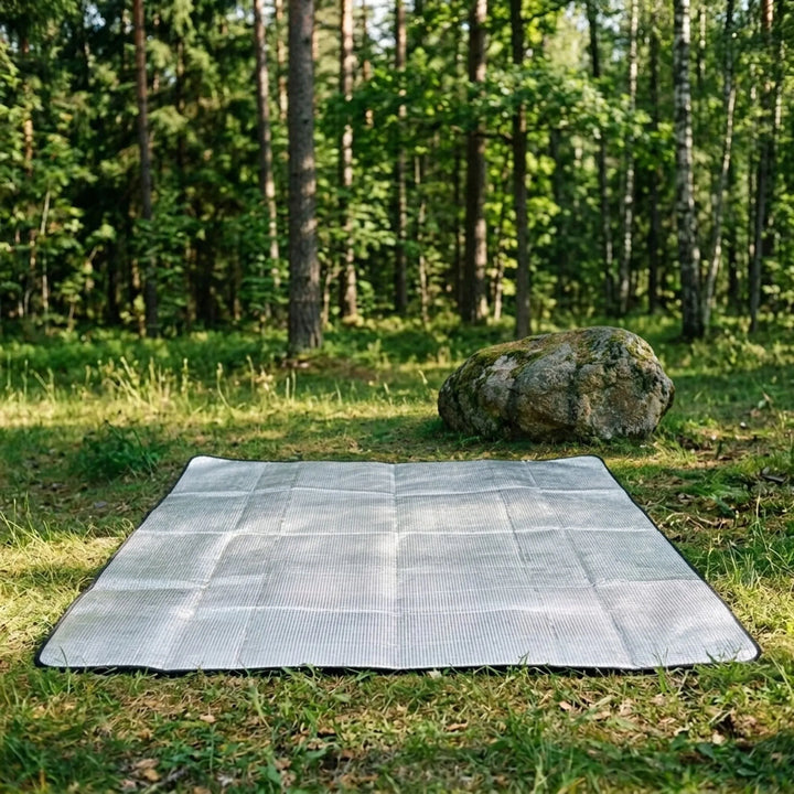 Unisex foldable camping mat with reflective insulation for lightweight outdoor sleeping & hiking adventures.