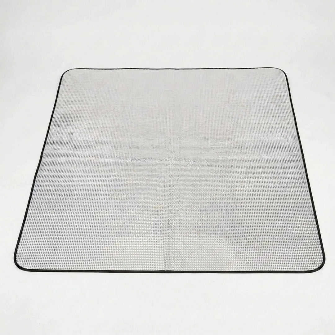 Reflective sleeping pad for camping, hiking, or picnics. Foldable design offers insulation & comfort.