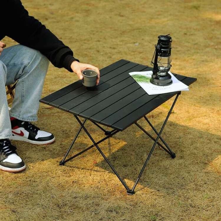 Unisex folding portable camping table with storage net, ideal for outdoor picnics and travel