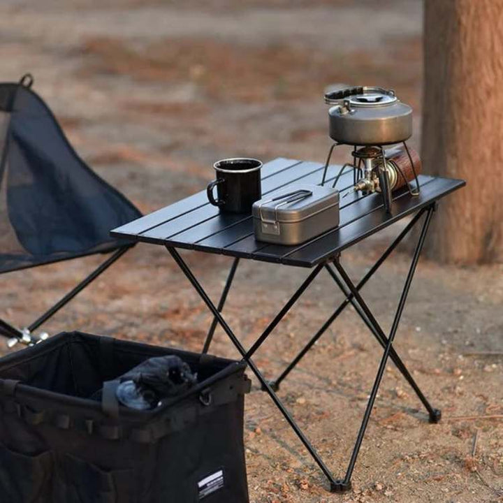 Portable picnic table with durable aluminum top, perfect for outdoor gear and travel