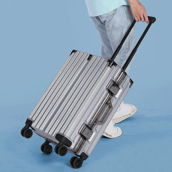 Close-up of secure TSA-approved lock on the aluminum frame of a hard shell suitcase.