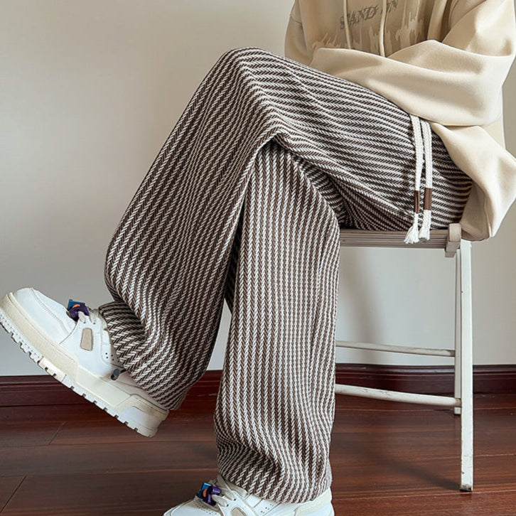 Stylish pink unisex herringbone loungewear sweatpants, relaxed fit with wide leg for ultimate comfort.