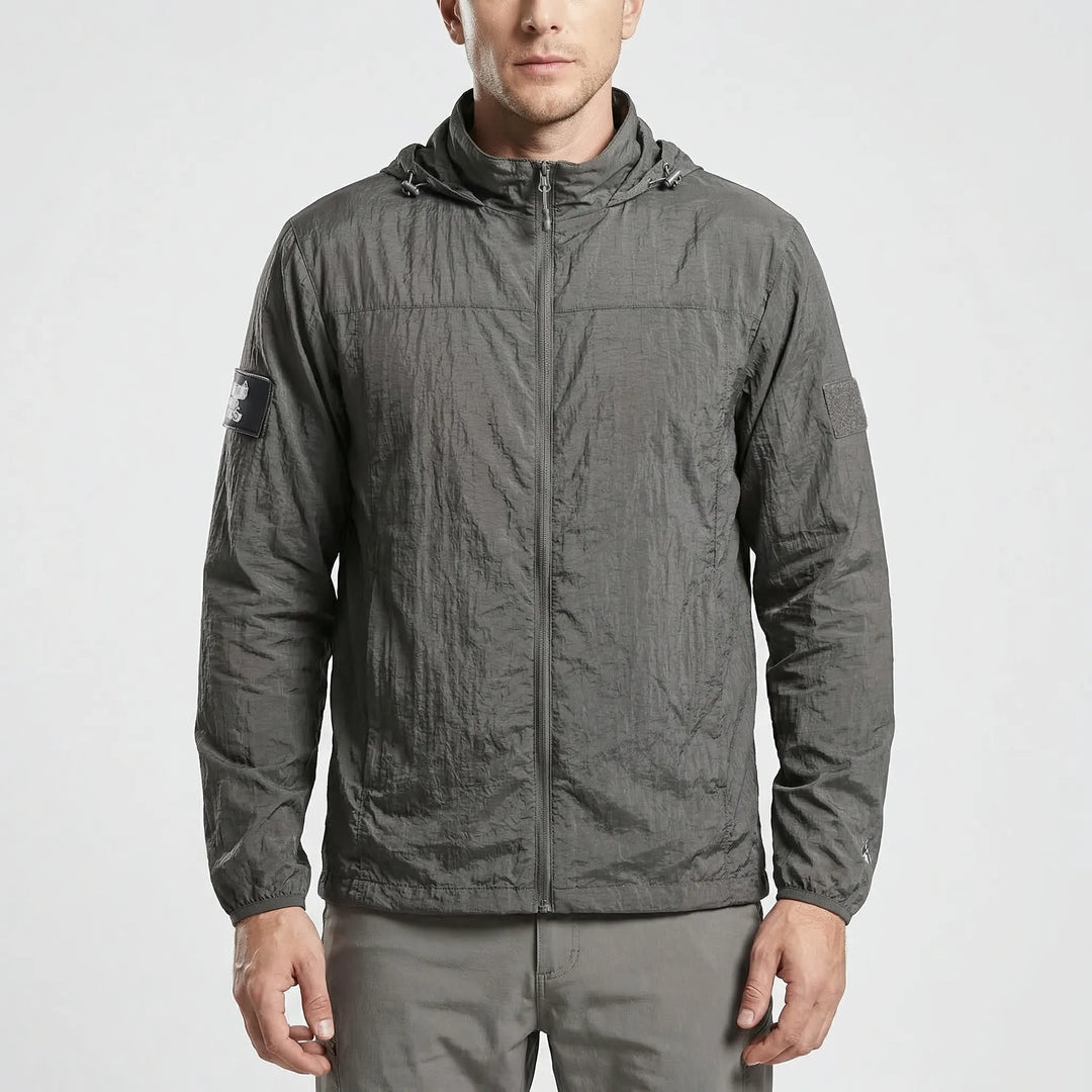 Folded lightweight tactical windbreaker jacket, compact & quick-dry, easy to pack for hiking and outdoor adventures.