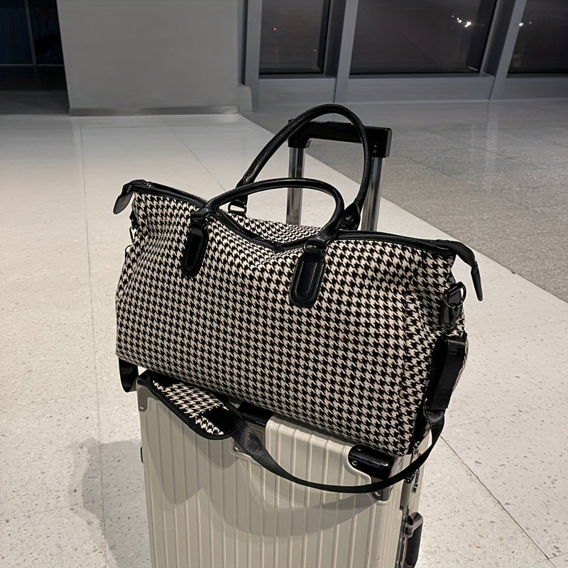 Adjustable strap on a stylish houndstooth weekender bag. Vegan leather travel duffle, unisex carry-on.