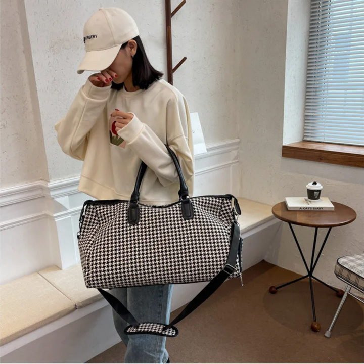Houndstooth vegan leather travel duffle bag. Unisex carry-on weekender, durable and stylish for journeys.