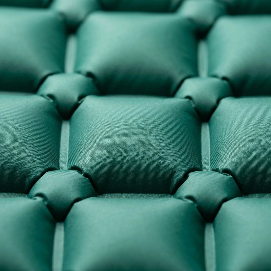 Comfortable camping sleeping pad with integrated pillow, perfect for restful outdoor sleep & hiking.