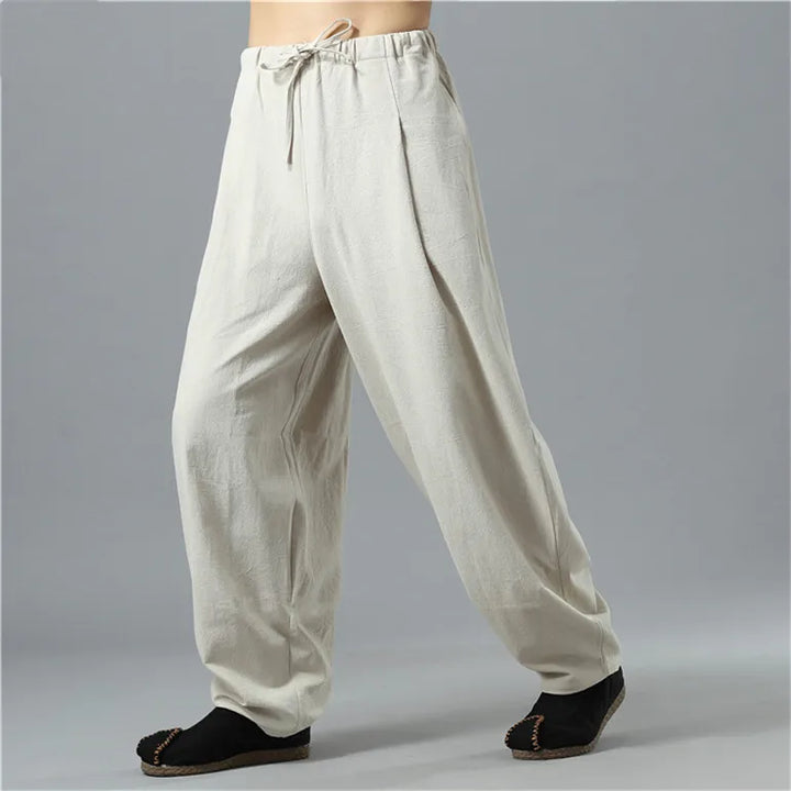 Person lounging in comfortable unisex Kodama baggy pants, perfect for ultimate relaxation and lounge wear.