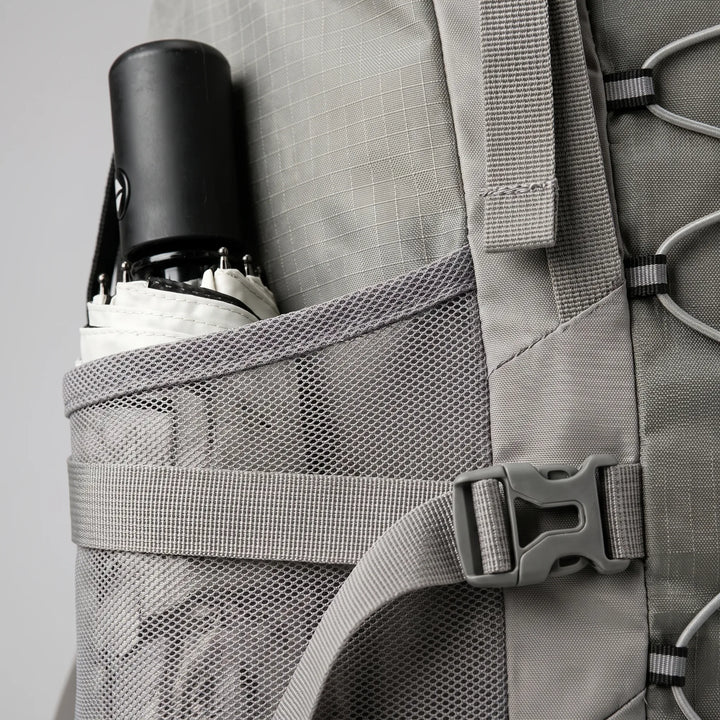 Rugged camping backpack standing amidst a scenic trail, ready for multi-day outdoor expeditions.