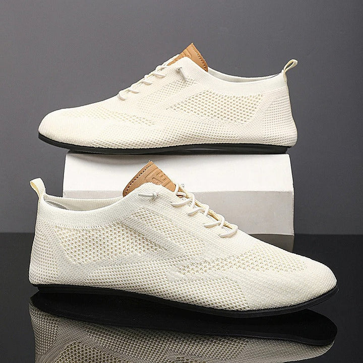 Comfortable slip-on knit sneakers for men and women, lightweight mesh design for breathability.
