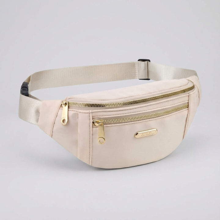 Person wears a lightweight nylon fanny pack as a crossbody bag for secure travel essentials.
