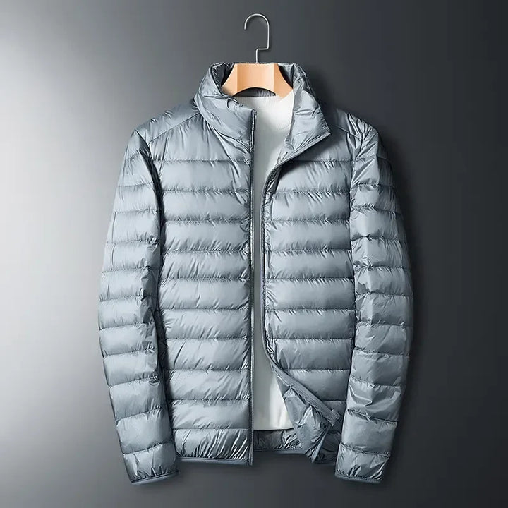 Unisex lightweight packable puffer jacket for versatile cold weather outdoor adventures and travel. Waterproof design.