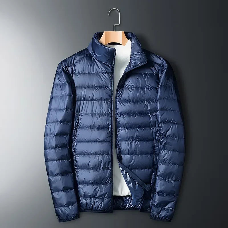 Warm unisex puffer jacket, lightweight and packable, perfect for men and women in cold weather and winter activities.