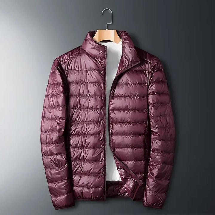 Stylish unisex puffer jacket, lightweight, packable, and versatile for everyday wear or outdoor winter adventures.