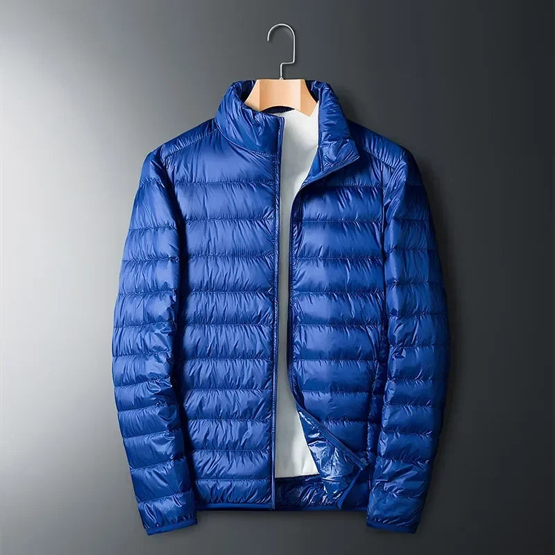 Essential unisex lightweight travel jacket, packable puffer for cold weather and outdoor adventures. Waterproof warmth.