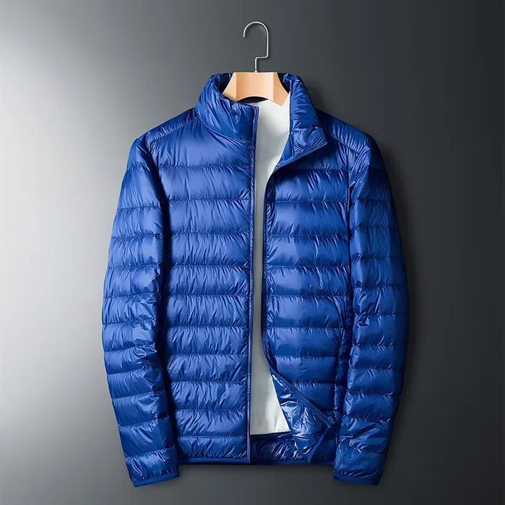 Essential unisex lightweight travel jacket, packable puffer for cold weather and outdoor adventures. Waterproof warmth.