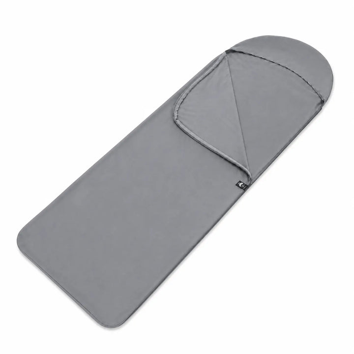 Close-up of a rectangle sleeping bag liner, showcasing its lightweight fabric, a must-have travel accessory.