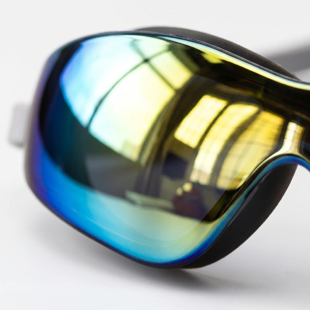 Close-up of sleek mirrored swimming goggles, designed for unisex comfort and glare protection for swimmers.