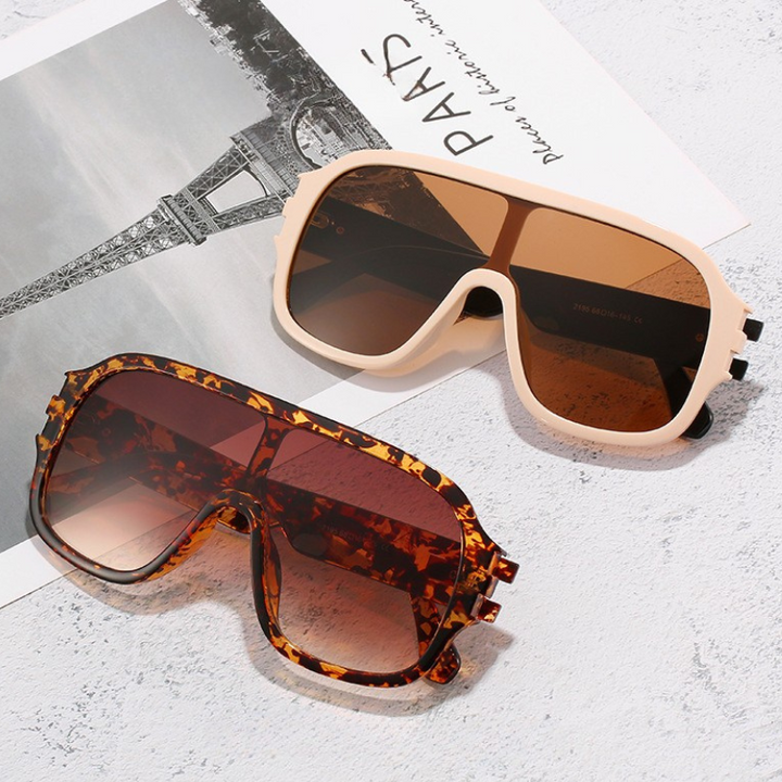 Fashionable unisex oversized sunglasses with trendy gradient lenses and sleek metal accents.