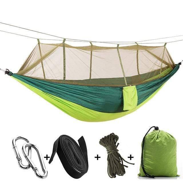 Outdoor portable camping hammock in a vibrant color with mosquito net, visible and functional.