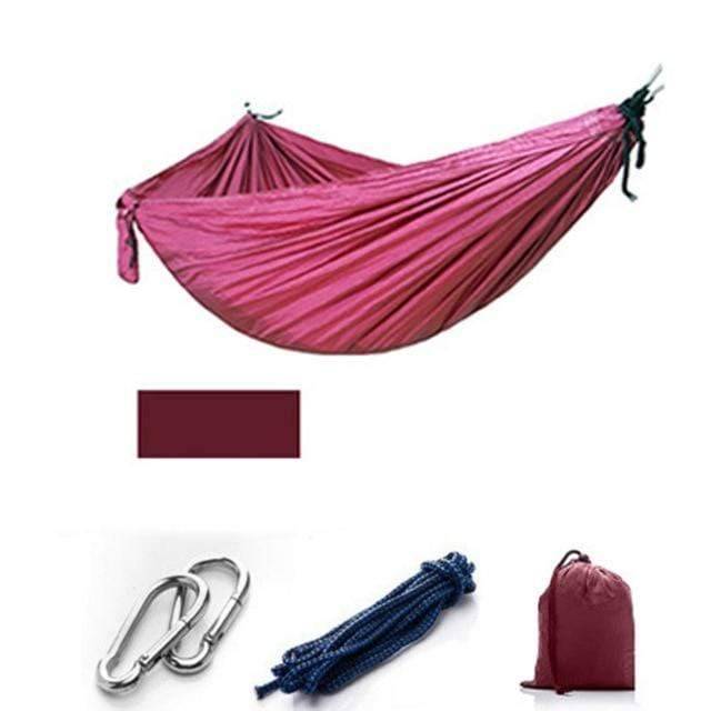 Camping hammock with mosquito net laid flat, showcasing its full size and bug-proof design.