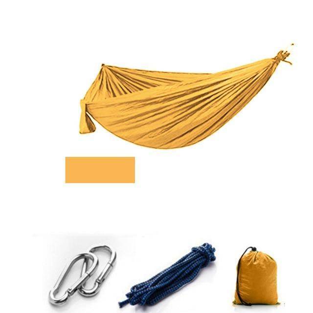 Portable camping hammock with suspension straps and mosquito net, ready for easy installation.