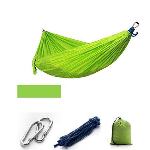 User enjoying a portable camping hammock with mosquito net, illustrating comfort and protection outdoors.
