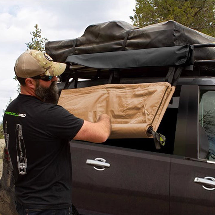 Car-mounted privacy shelter tent in use, providing shade and seclusion during camping trips.