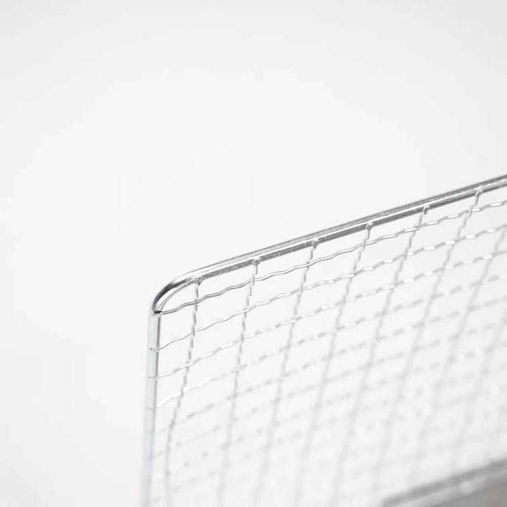 Detail of the locking mechanism on the folding portable stainless steel camping grill.