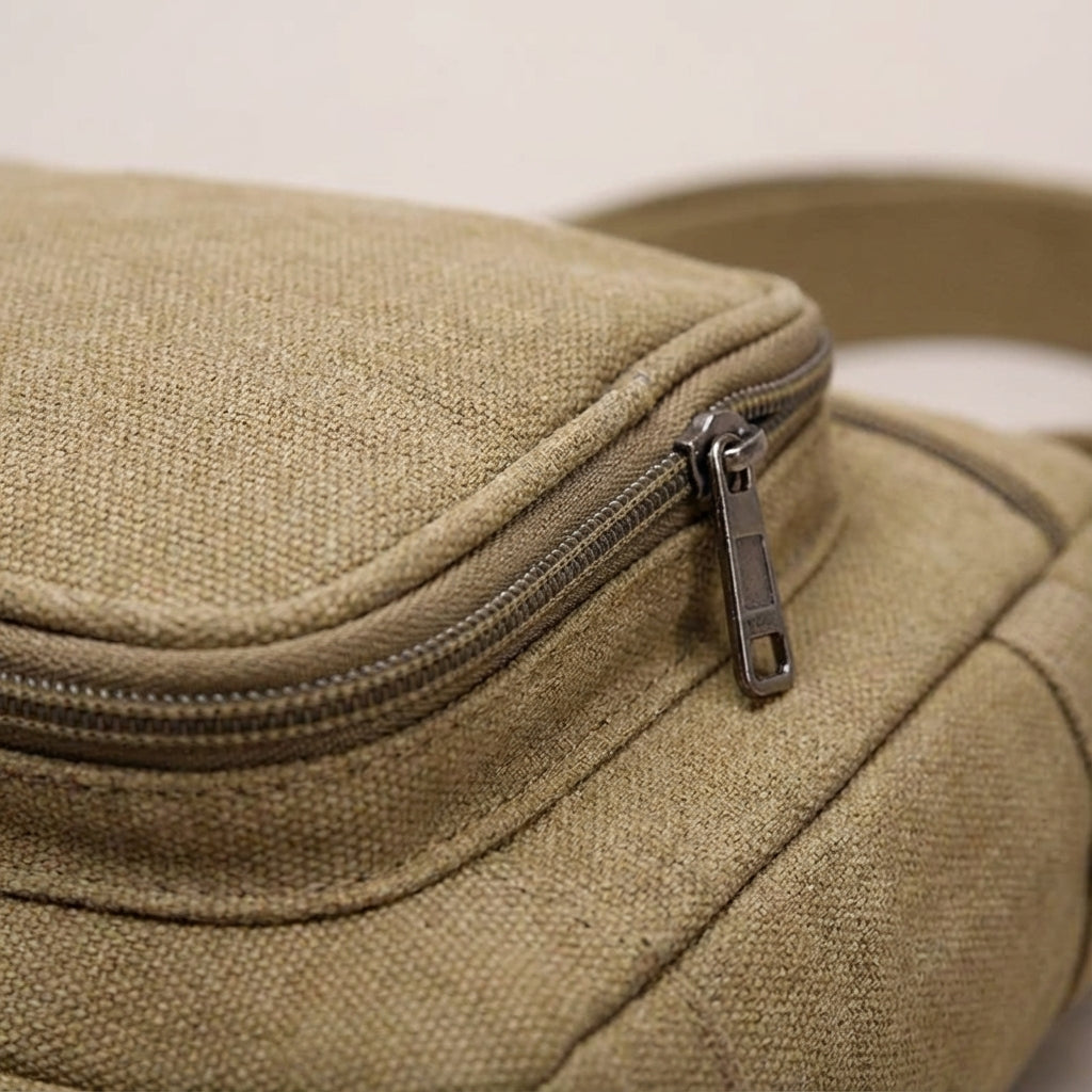 Stylish unisex retro canvas crossbody bag worn casually, ideal for urban exploration & daily carry. Durable design.