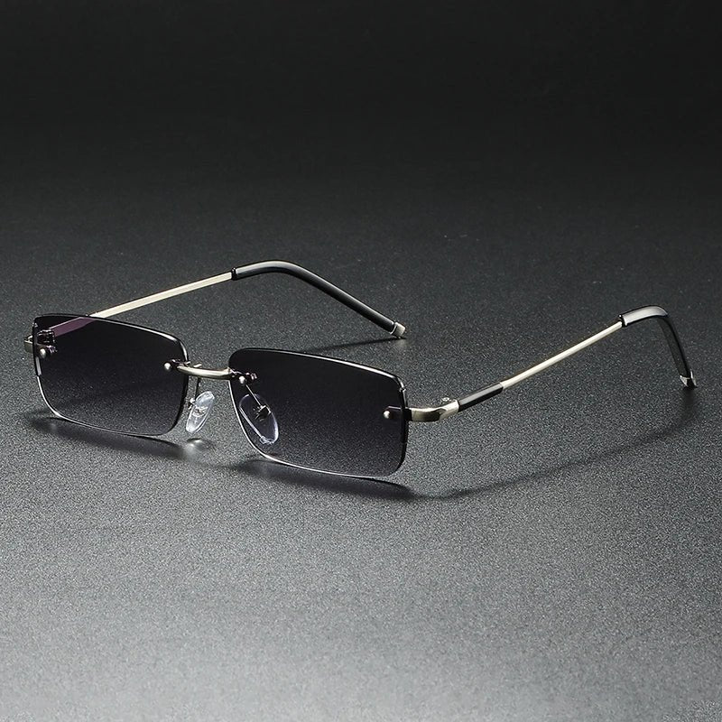 Stylish rimless rectangular sunglasses featuring gradient tinted lenses and a lightweight gold frame. UV protection.