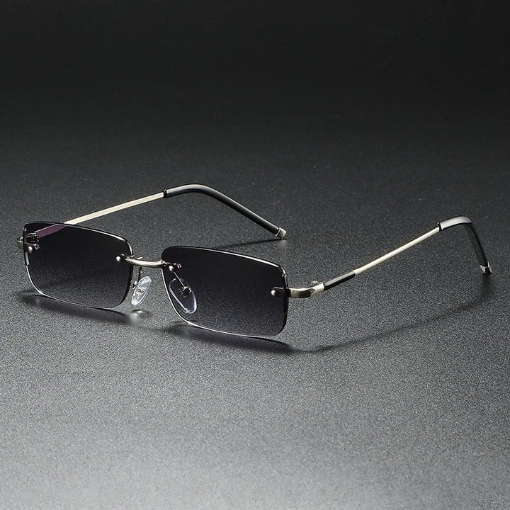 Stylish rimless rectangular sunglasses featuring gradient tinted lenses and a lightweight gold frame. UV protection.