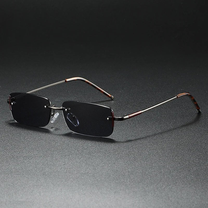 Elegant gold rimless rectangular sunglasses for men & women. Gradient tinted lenses offer UV protection & designer style.