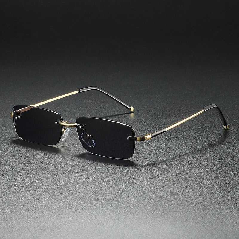Designer rimless rectangular sunglasses with gradient lenses. Gold accents, UV protection & elegant tinted eyewear.