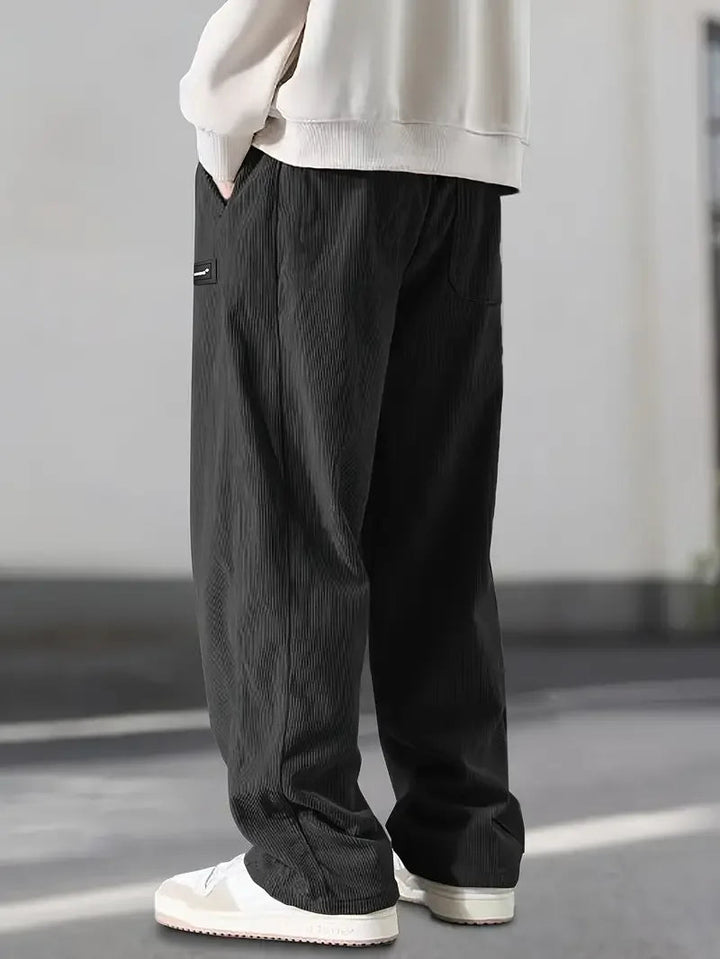 Unisex wide leg corduroy pants with an adjustable drawstring waist, ideal for a casual fit.