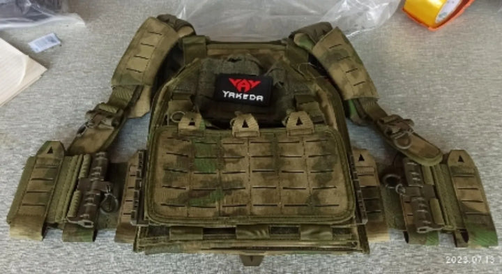 Side view of military style airsoft vest, adjustable plate carrier with quick release buckles