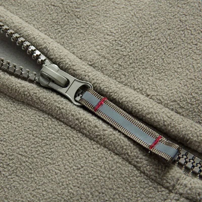 Close-up of waterproof zipper on unisex thermal fleece tactical jacket, windproof winter coat